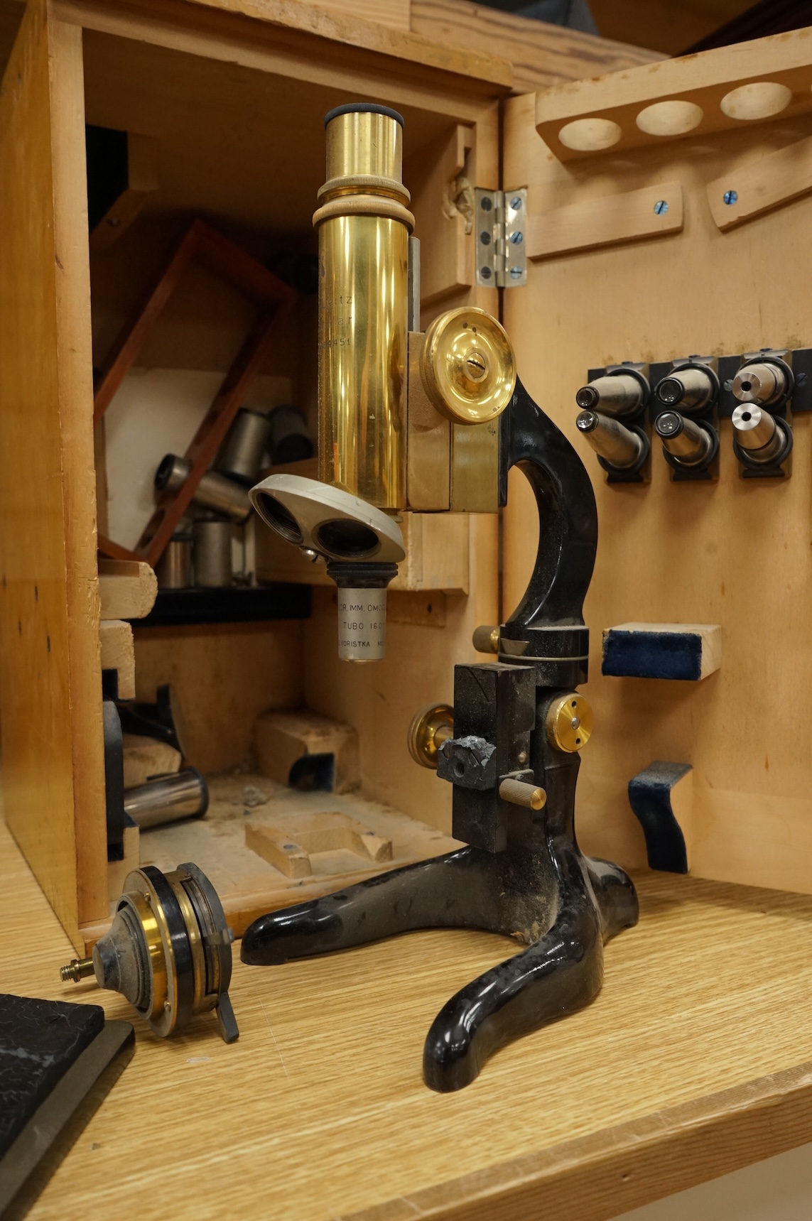 An early 20th century E. Leitz, Wetzlar, monocular microscope, in a cedar case, together with a number of alternative lenses and other accessories, case height 37.5cm.